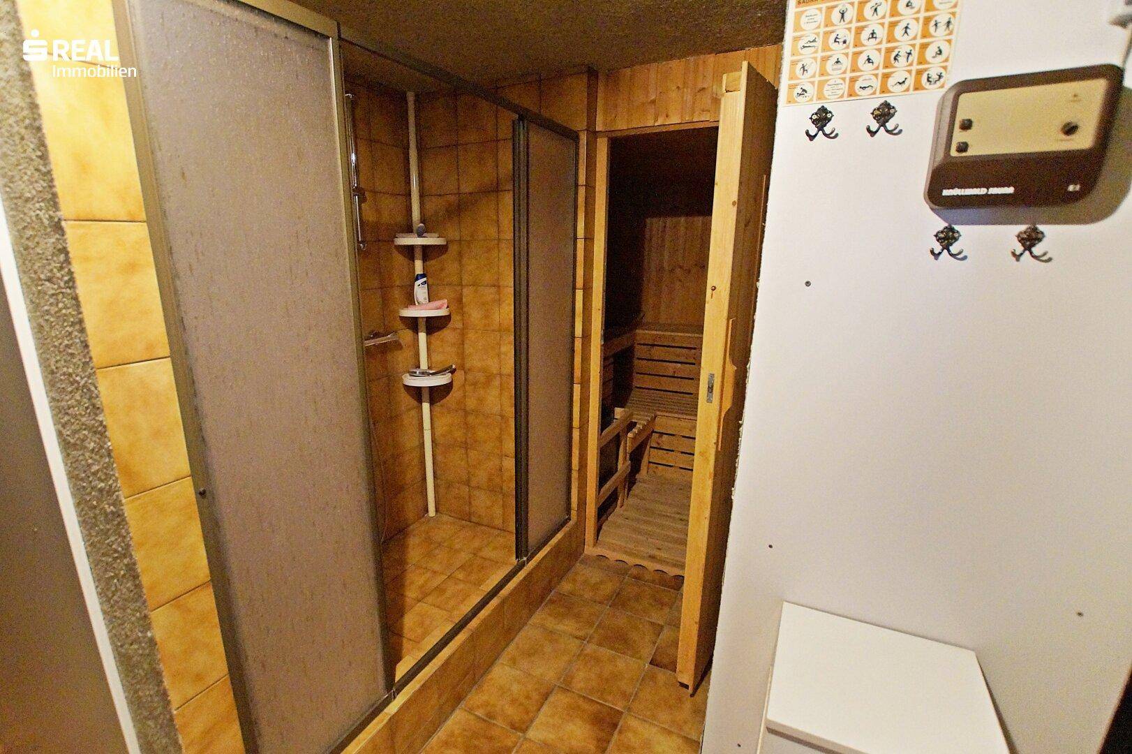 Kellerbad mit Dusche und integrierter Sauna, ideal für Wellness und Entspannung.