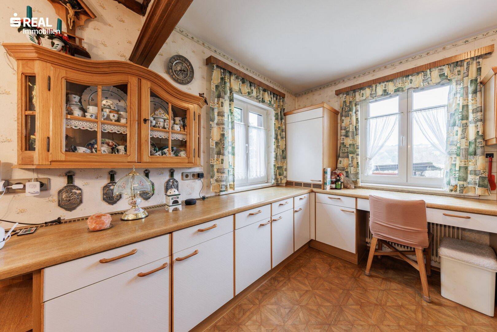 Traditionelle Küche mit weißen Schränken, Holztheke und viel Arbeitsfläche.