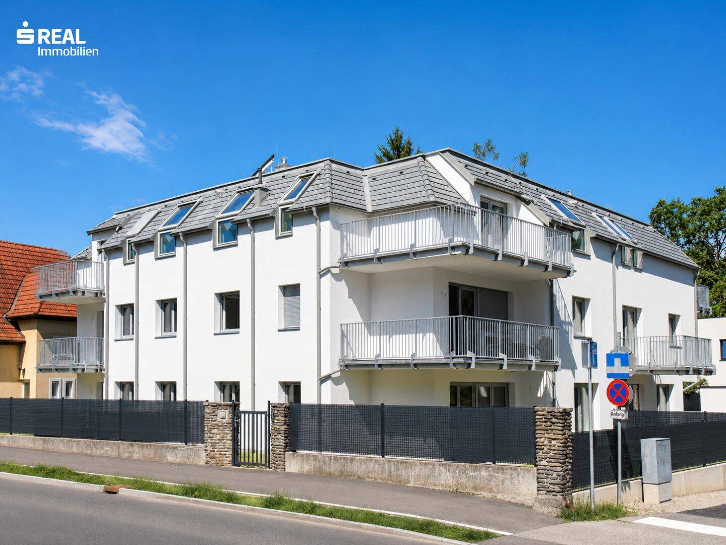 Attraktives Mehrfamilienhaus mit mehreren Balkonen und moderner Architektur in sonniger Lage.