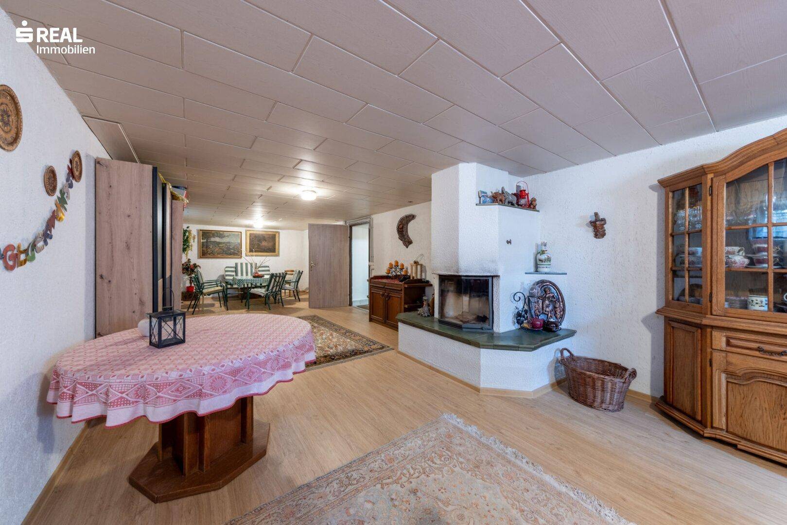 Weiterer Blick in den ausgebauten Keller mit Essbereich und Kamin.