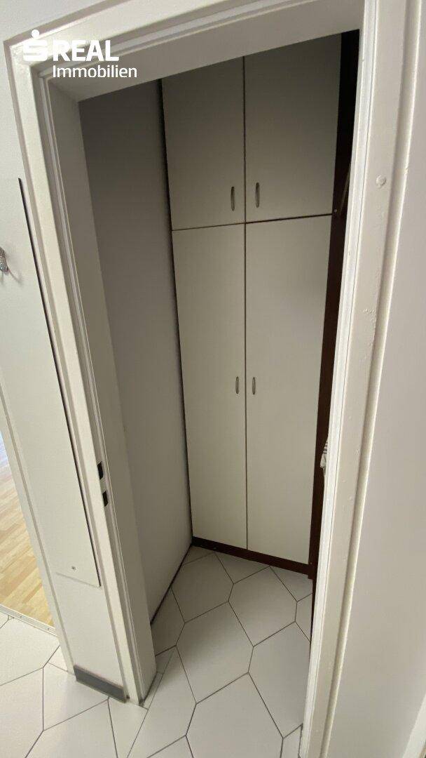 Praktischer Einbauschrank im Flur mit hellen Fliesen, bietet zusätzlichen Stauraum.
