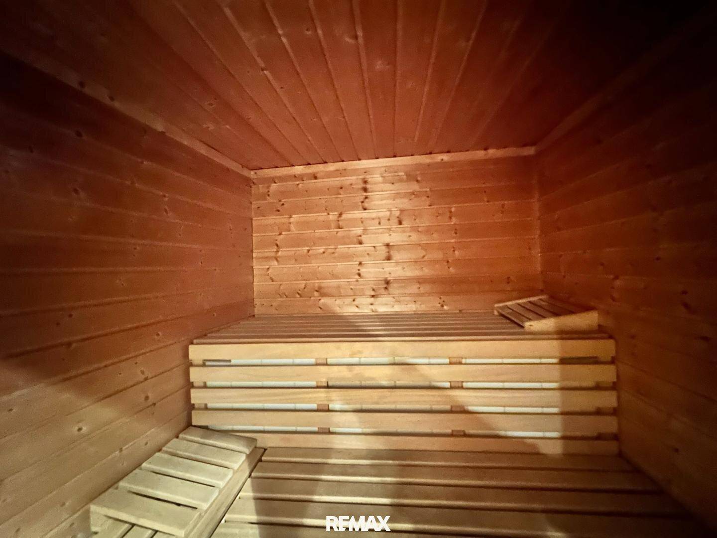 Traditionelle Holzsauna mit mehreren Bänken, bietet Platz für entspannende Momente.