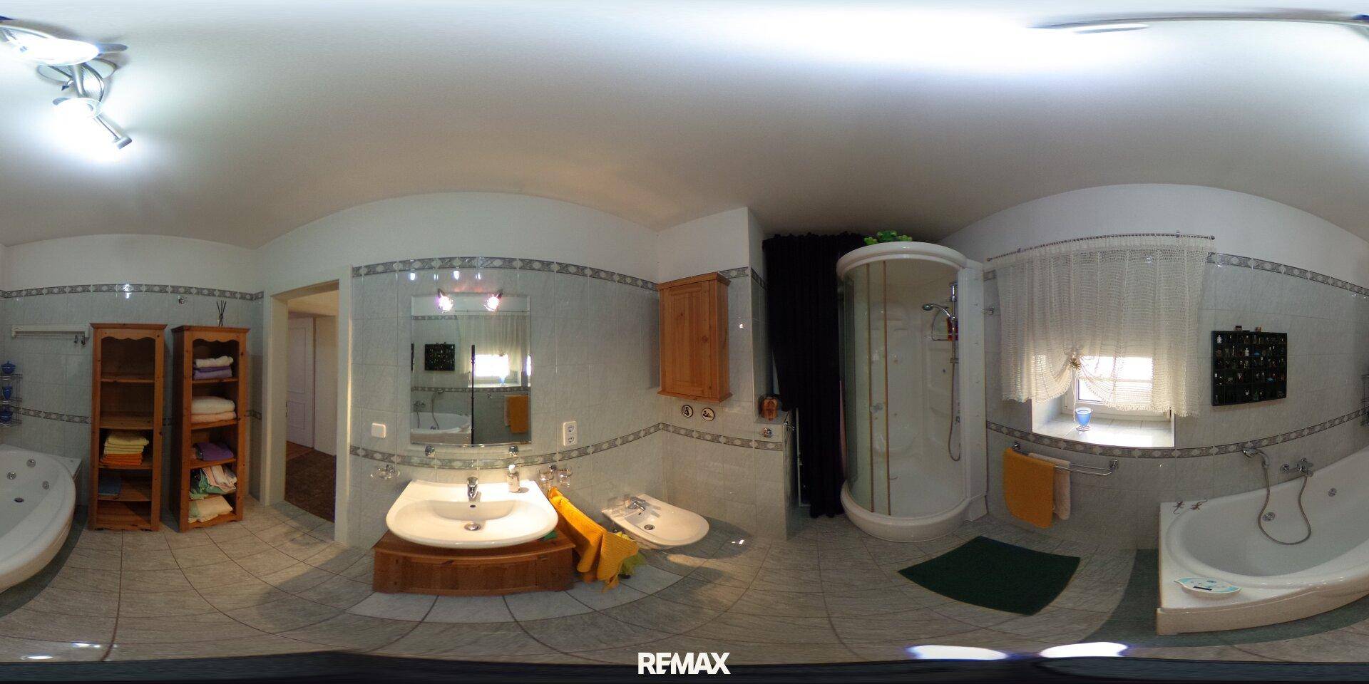 Geräumiges Badezimmer mit Badewanne, Duschkabine, Doppelwaschbecken und hellen Fliesen.