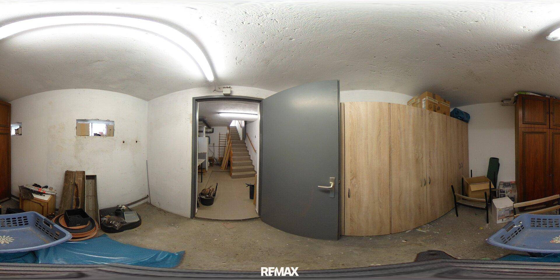 Heller Kellerraum mit Schränken und Zugang zur Treppe, bietet zusätzlichen Stauraum.