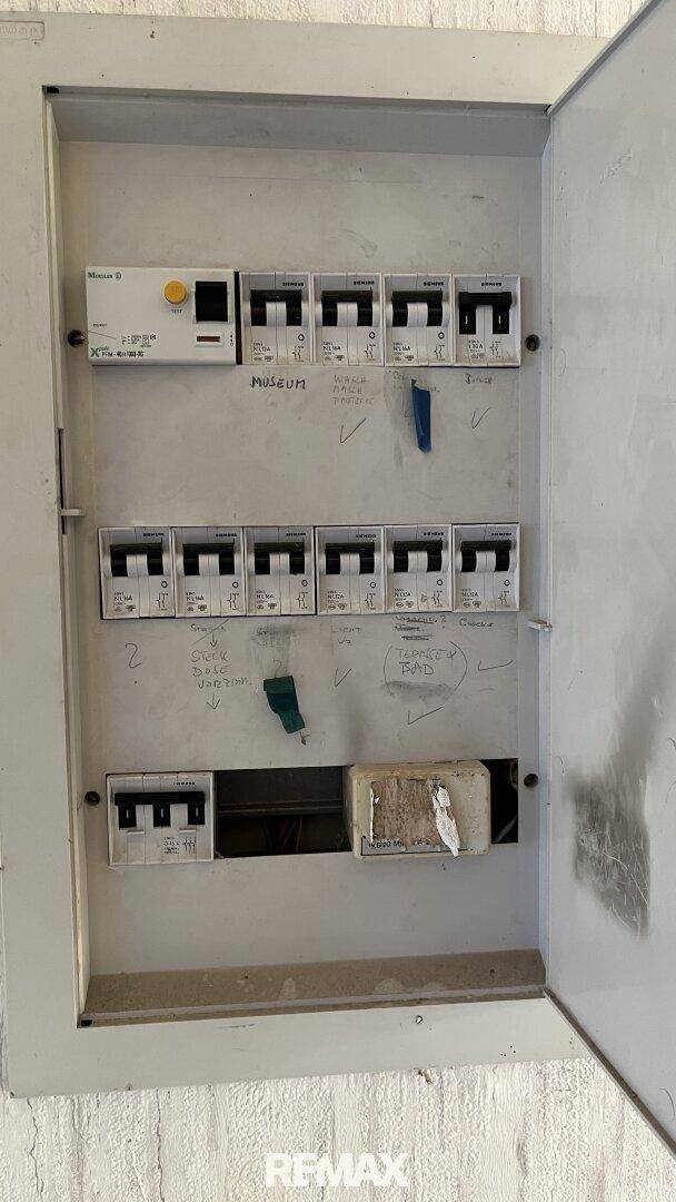 Geschlossener Sicherungskasten mit Beschriftungen, der die elektrische Installation des Hauses zeigt.