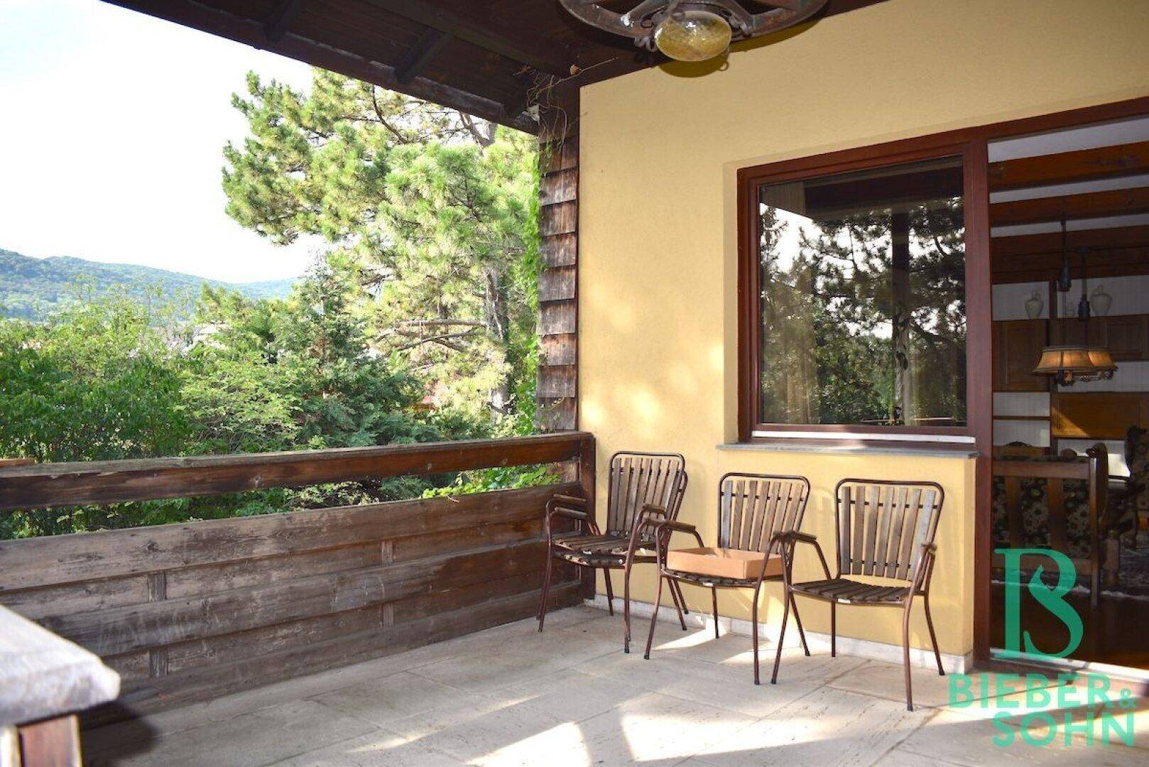 Geräumige Terrasse mit Gartenmöbeln und schöner Aussicht auf die Umgebung.