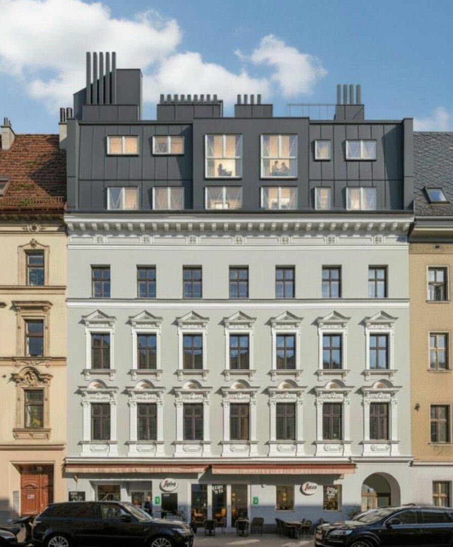 Moderne Dachaufstockung auf einem historischen Gebäude mit eleganter Fassade und großen Fenstern.