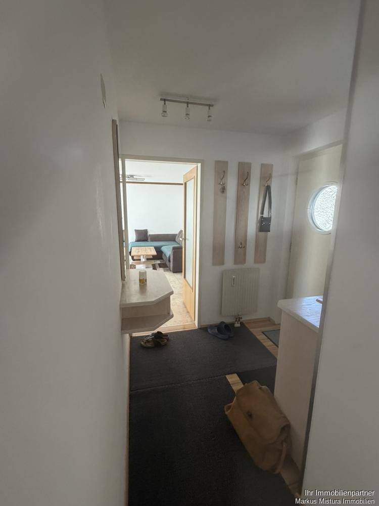 Eingangsbereich mit Garderobe und Blick in den Wohnbereich.