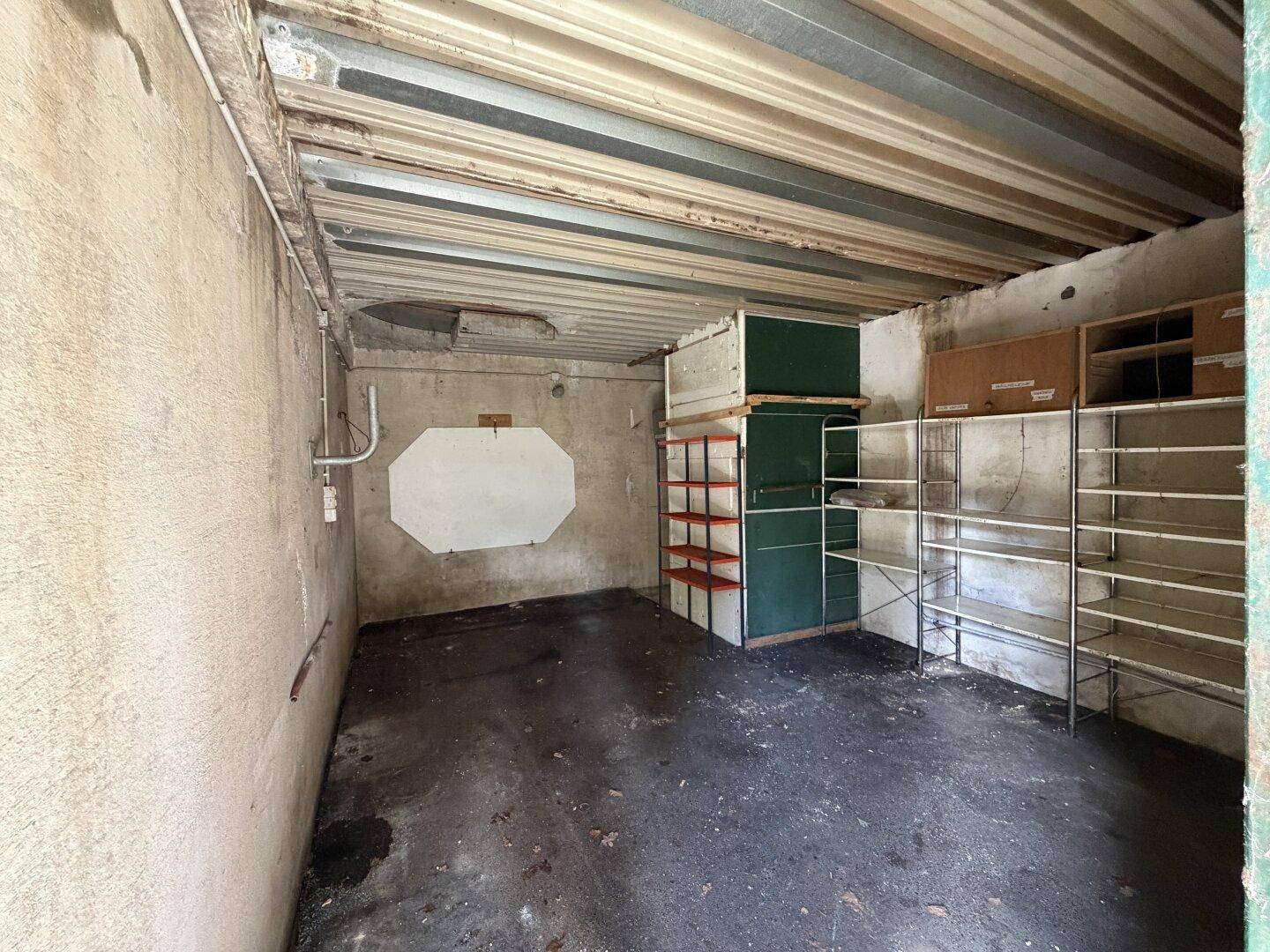Abstellraum mit Regalen und einfacher Ausstattung, ideal für Lagerzwecke und mit sichtbaren Deckenbalken.