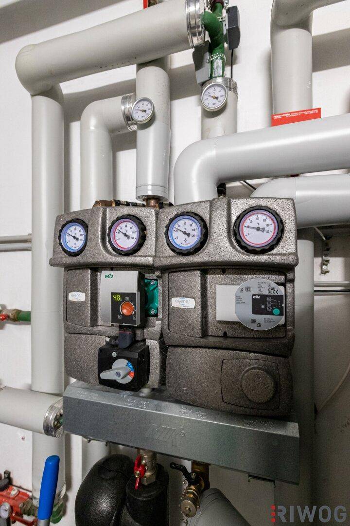 Detailansicht der Steuerungselemente und Pumpen der Heizungsanlage.