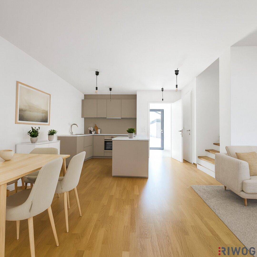 Helles, offenes Wohn- und Esszimmer mit integrierter Küche und modernem Holzfußboden.