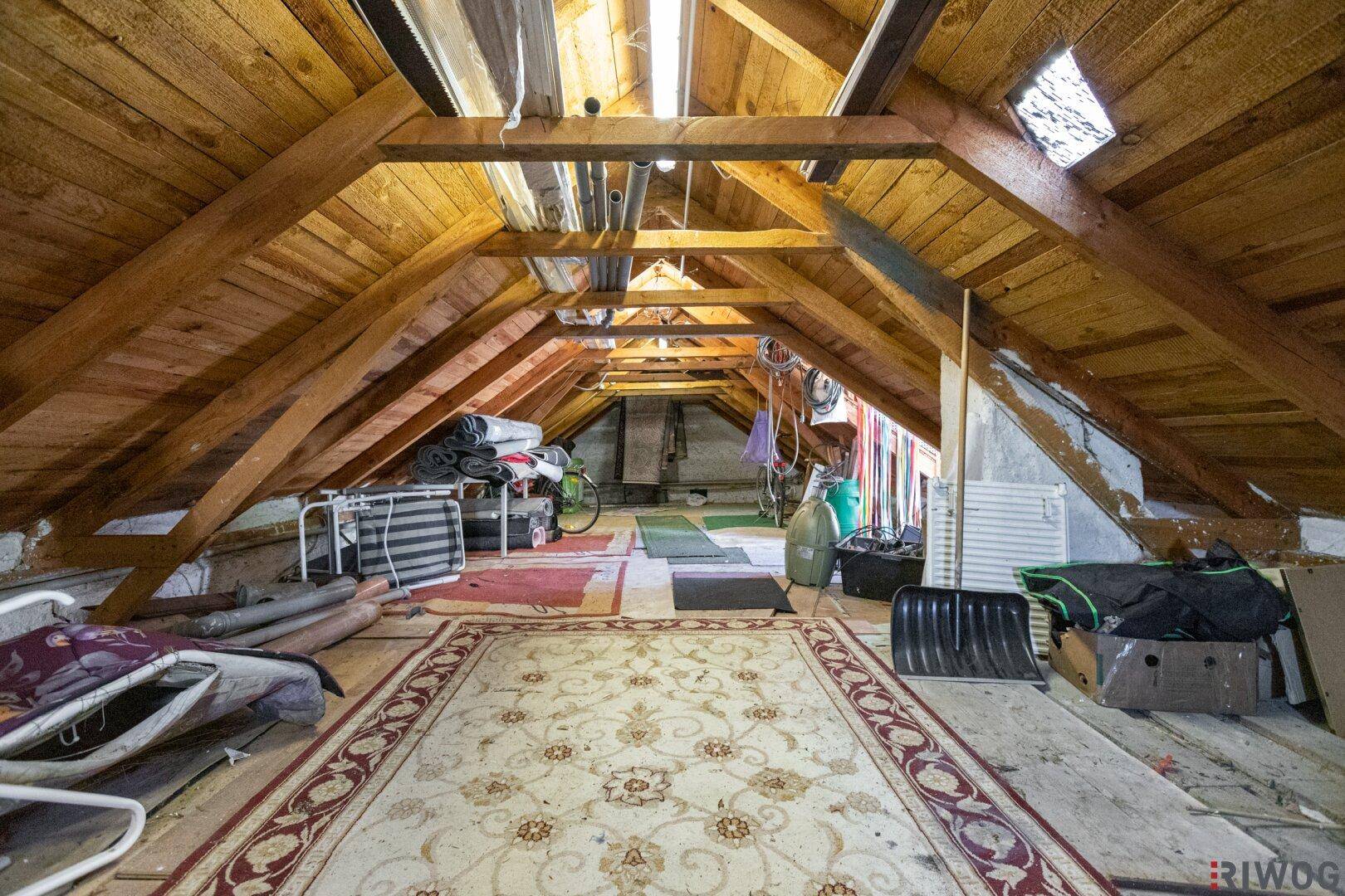 Geräumiger Dachboden mit sichtbaren Holzbalken, ideal als zusätzlicher Stauraum.