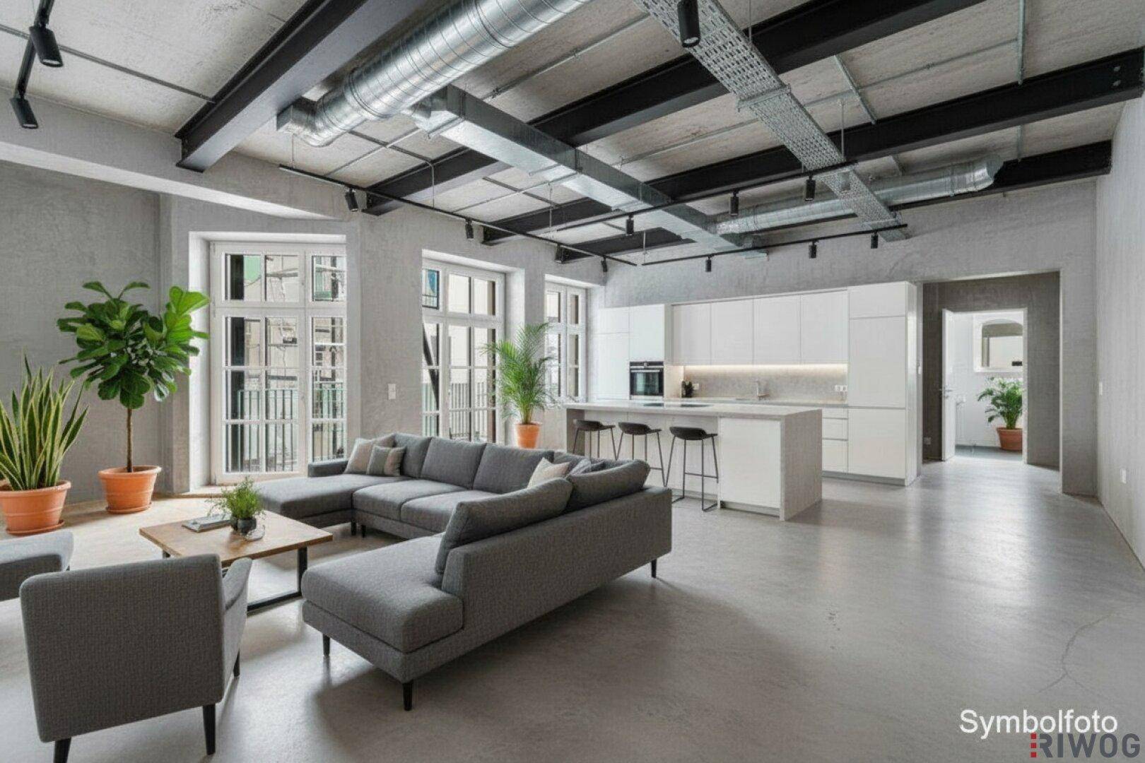 Modernes Loft mit offener Küche, Wohnbereich, hohen Decken und sichtbaren Lüftungsrohren im Industriestil.
