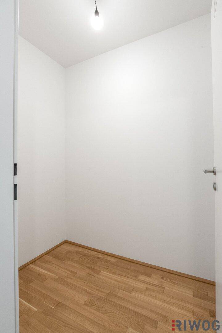 Praktischer Abstellraum mit Parkettboden und weißen Wänden, bietet zusätzlichen Stauraum.