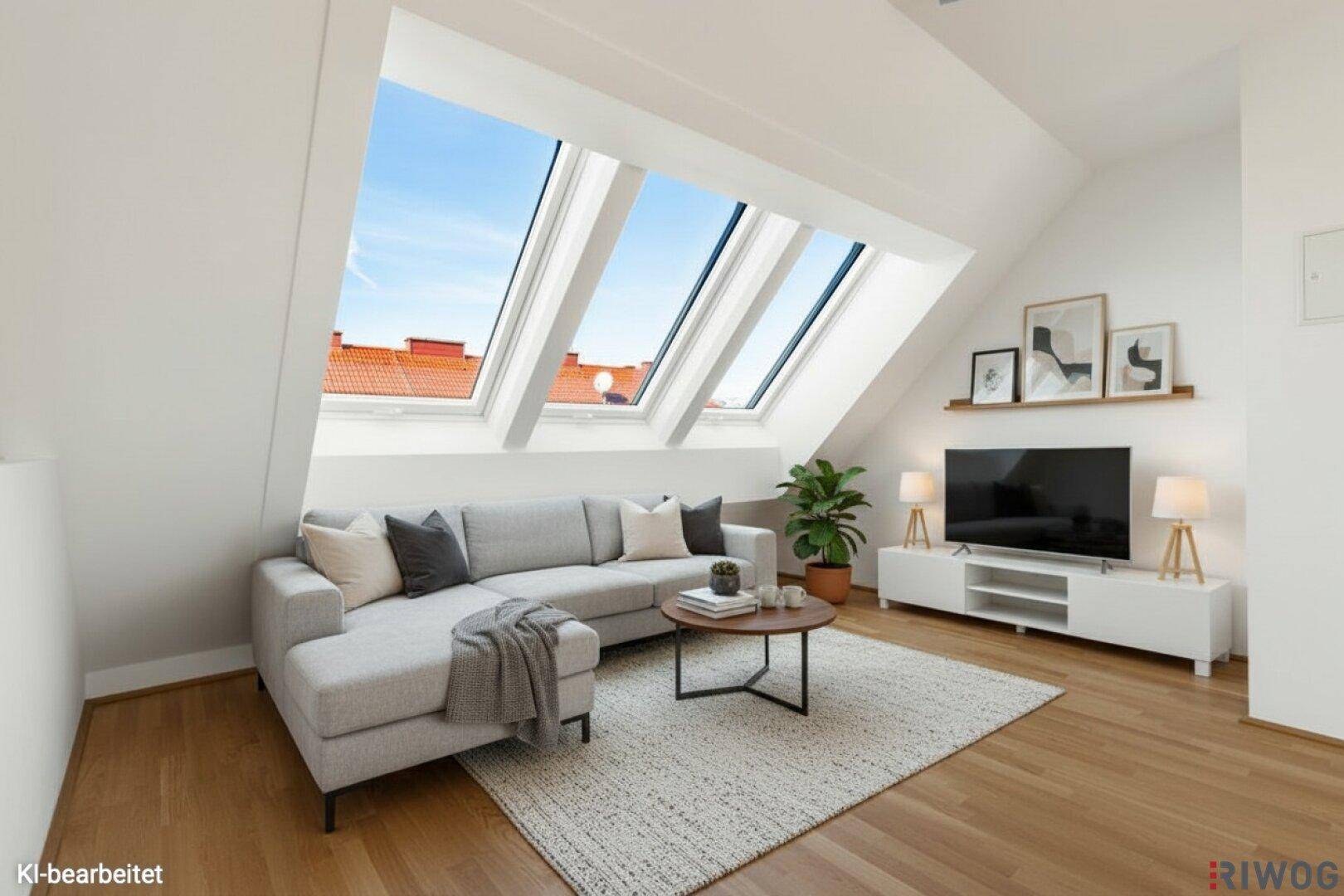 Modern eingerichtetes Wohnzimmer mit Dachschrägen, großen Dachfenstern und Holzboden.