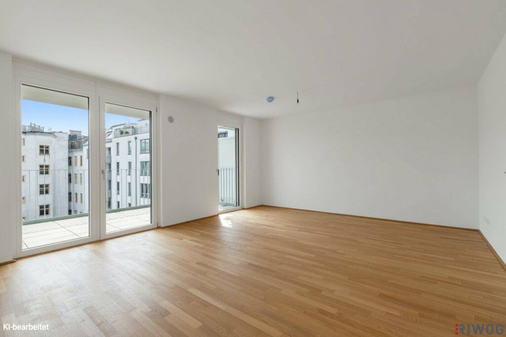 Geräumiges Wohnzimmer mit hellem Parkettboden und großen Fenstern.
