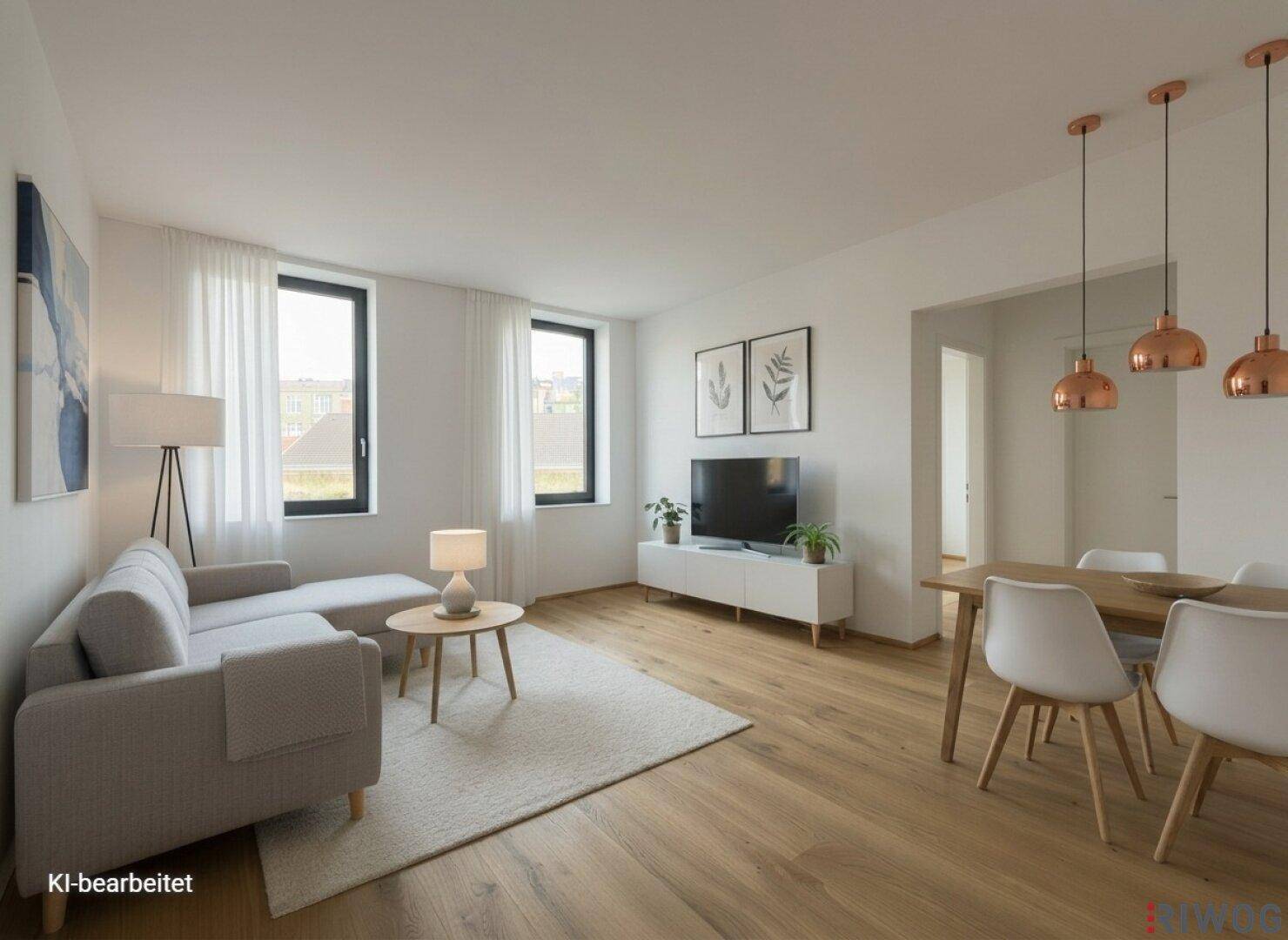 Heller offener Wohn- und Essbereich mit Holzboden und moderner Einrichtung, perfekt für geselliges Beisammensein.