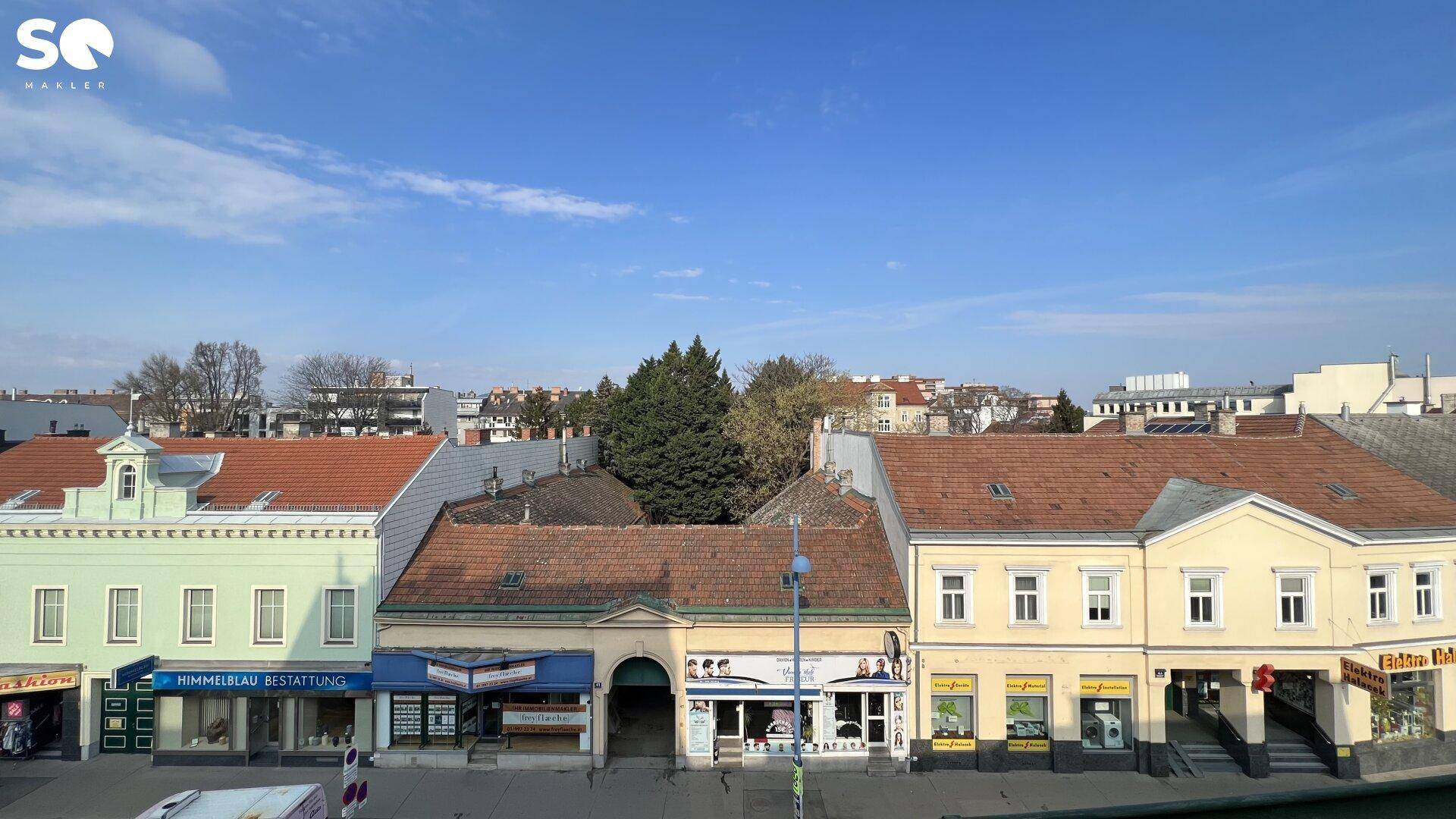 Panoramablick über die städtische Umgebung mit verschiedenen Gebäuden und Dächern.
