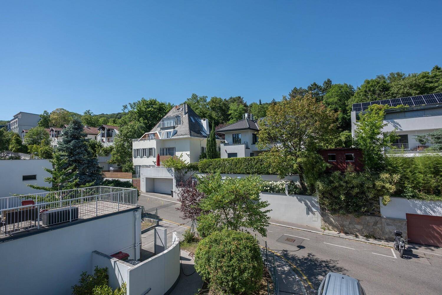 Panoramablick auf die ruhige Wohngegend mit viel Grün und modernen Gebäuden.