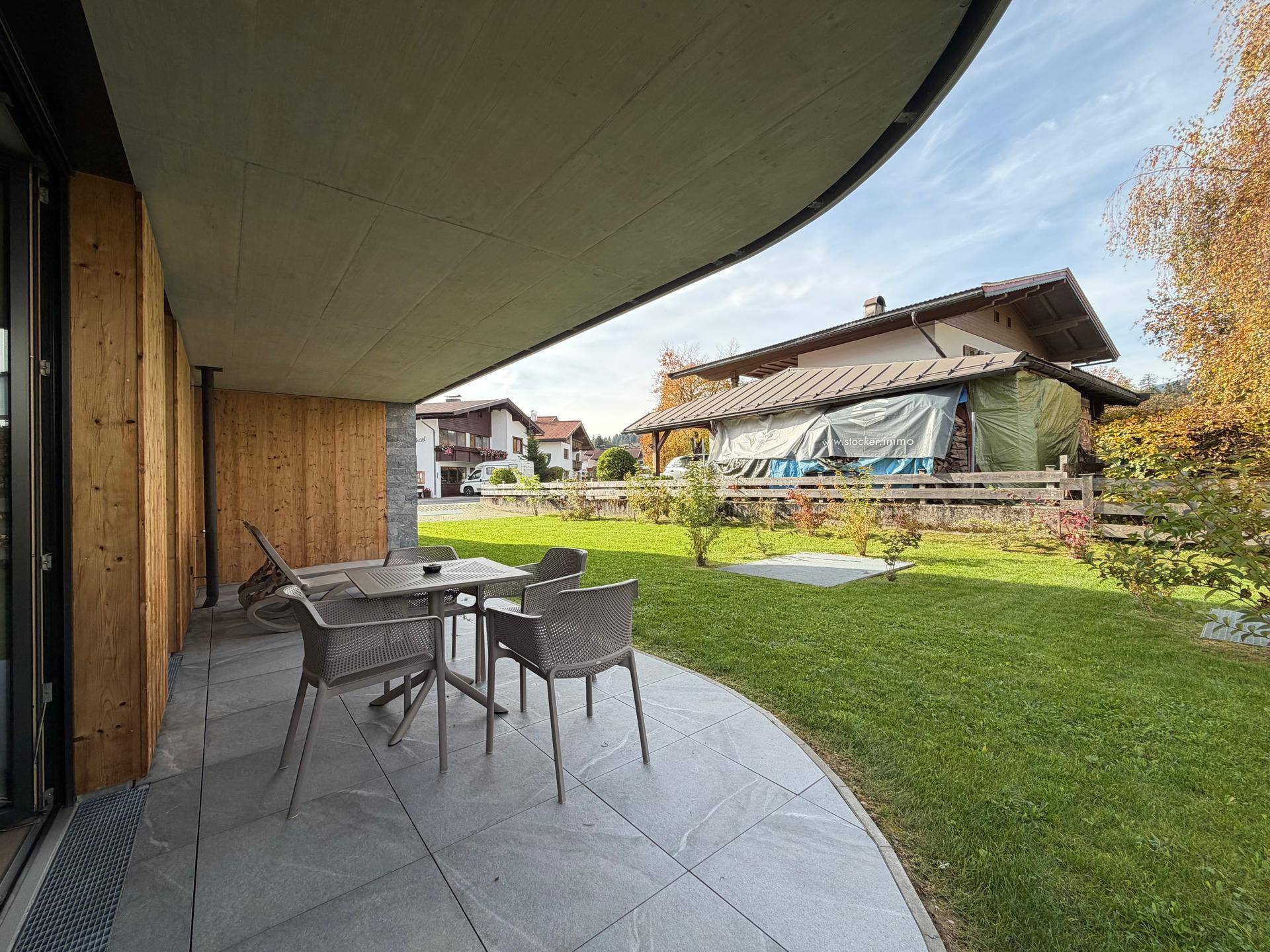 Große Terrasse mit Gartenmöbeln und Blick auf die umliegende Wohngegend.