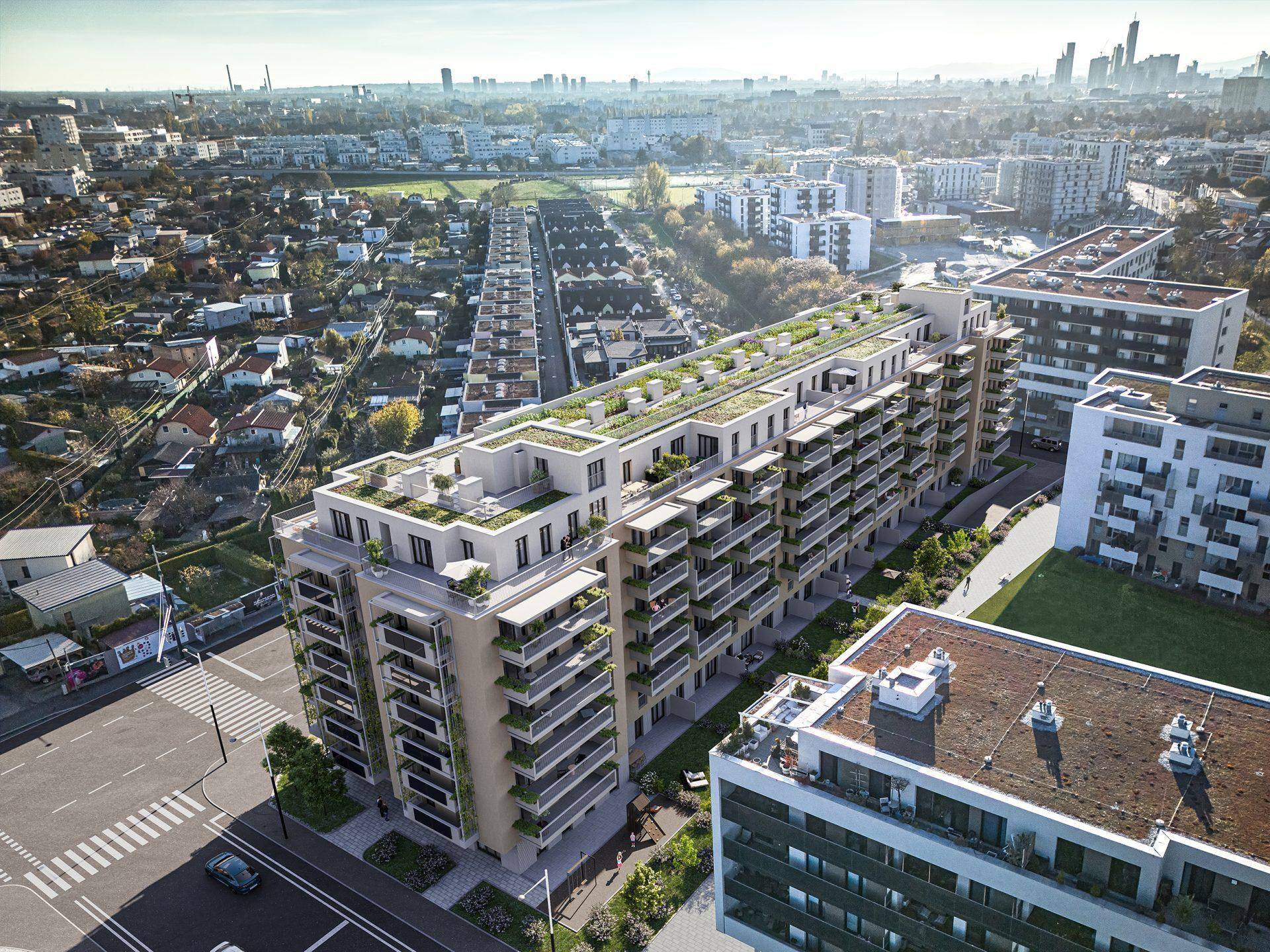 Luftaufnahme eines modernen Wohnkomplexes mit begrünten Dächern in städtischer Umgebung.