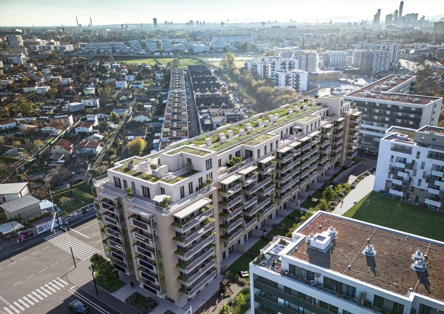 Luftaufnahme eines großen Wohnkomplexes in einer städtischen Umgebung mit viel Grün.