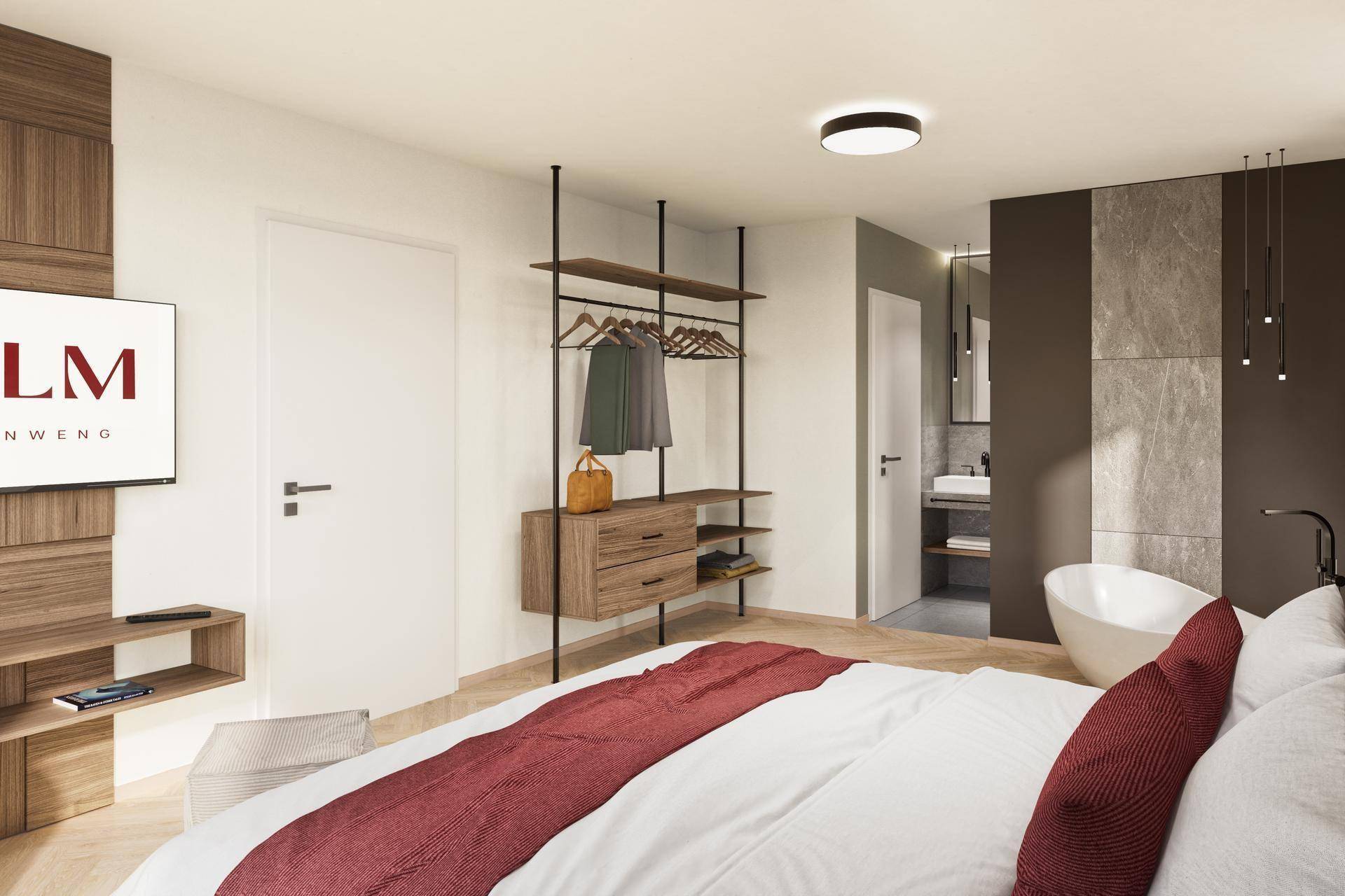 Schlafzimmer mit offenem Kleiderschrank, freistehender Badewanne und Blick ins Badezimmer.