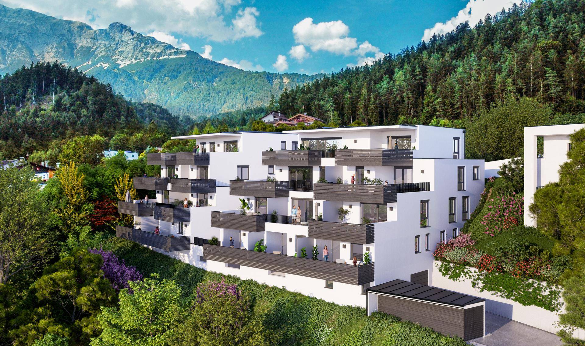 Moderne Wohnanlage in Hanglage mit mehreren Balkonen und Terrassen, umgeben von grünen Bergen.