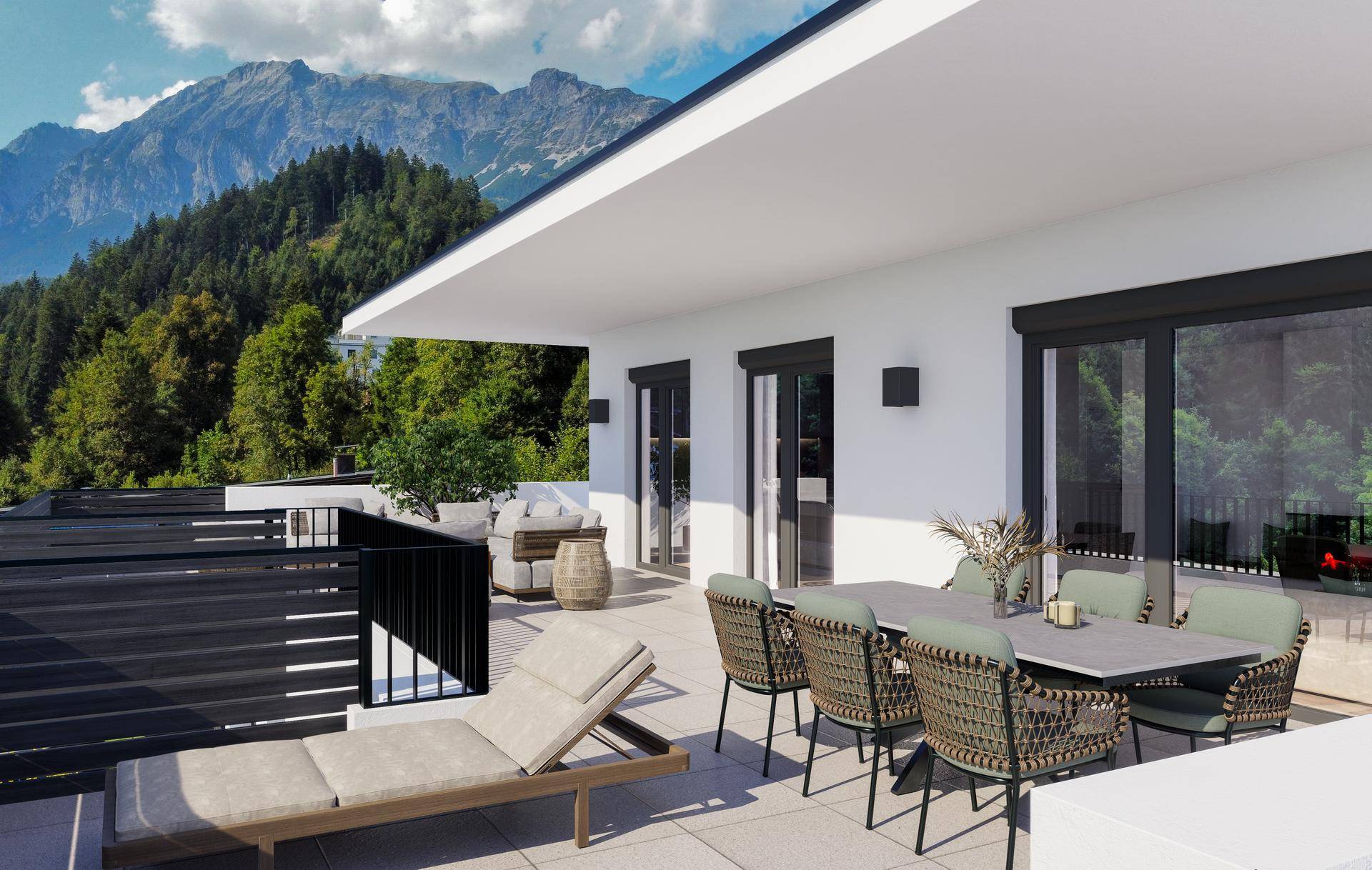 Große Terrasse mit Essbereich und Liegestuhl, bietet einen weiten Blick auf die umliegende Berglandschaft.