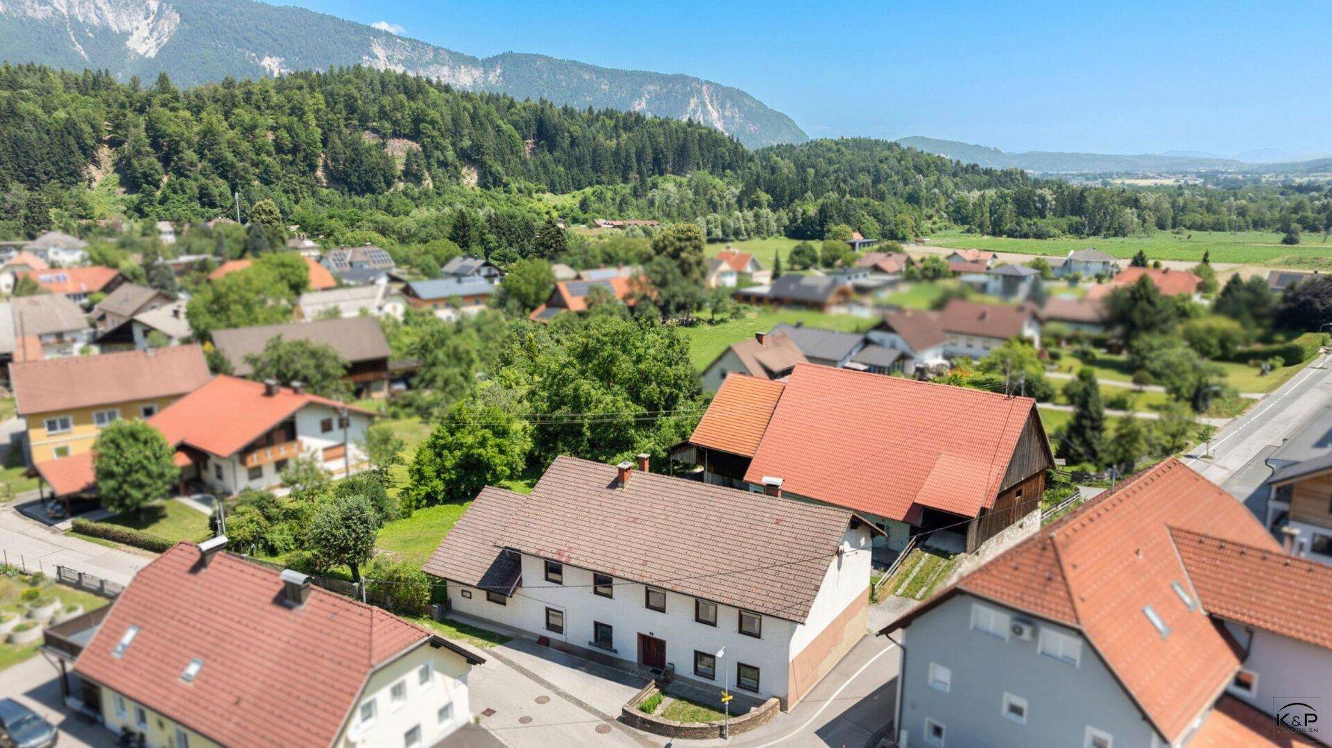 Überblick über die ländliche Siedlung mit mehreren Häusern und grüner Umgebung.