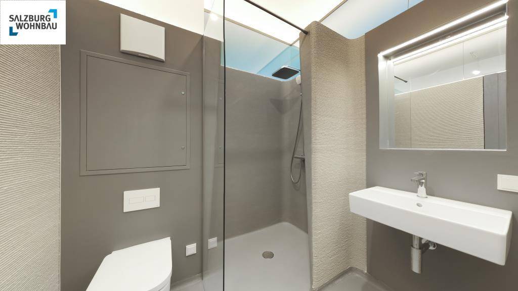 Modernes Badezimmer in Grau mit bodengleicher Dusche, wandhängendem WC und schwebendem Waschbecken.