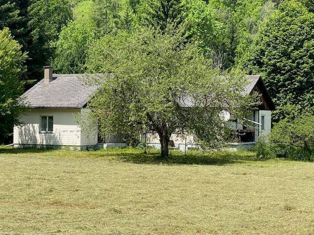 Das ländliche Wohnhaus präsentiert sich mit einer schlichten Architektur inmitten einer idyllischen Naturlandschaft.