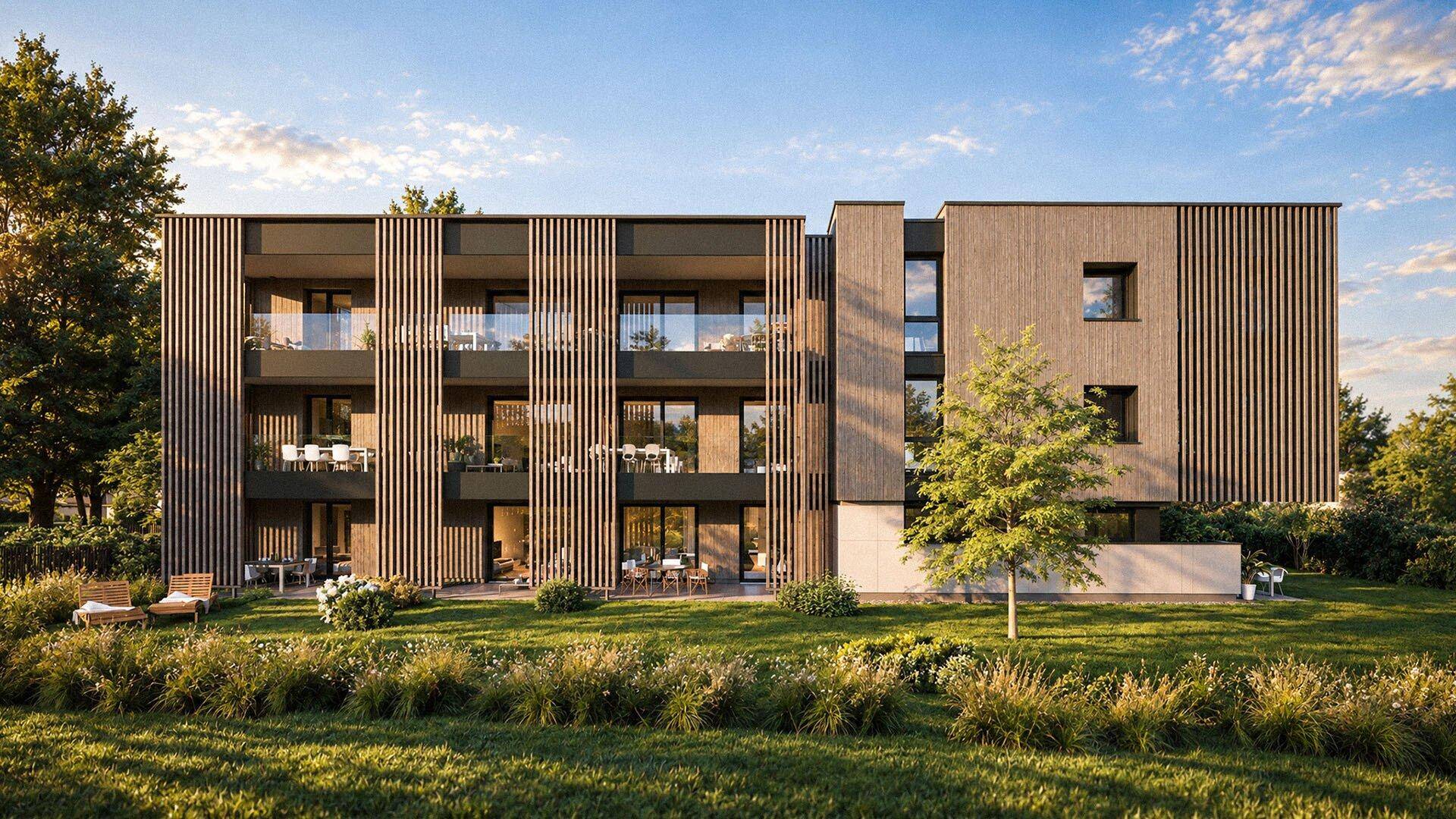 Moderne Gebäudefassade mit Holzverkleidung, Balkonen und weitläufiger Grünfläche im Vordergrund.