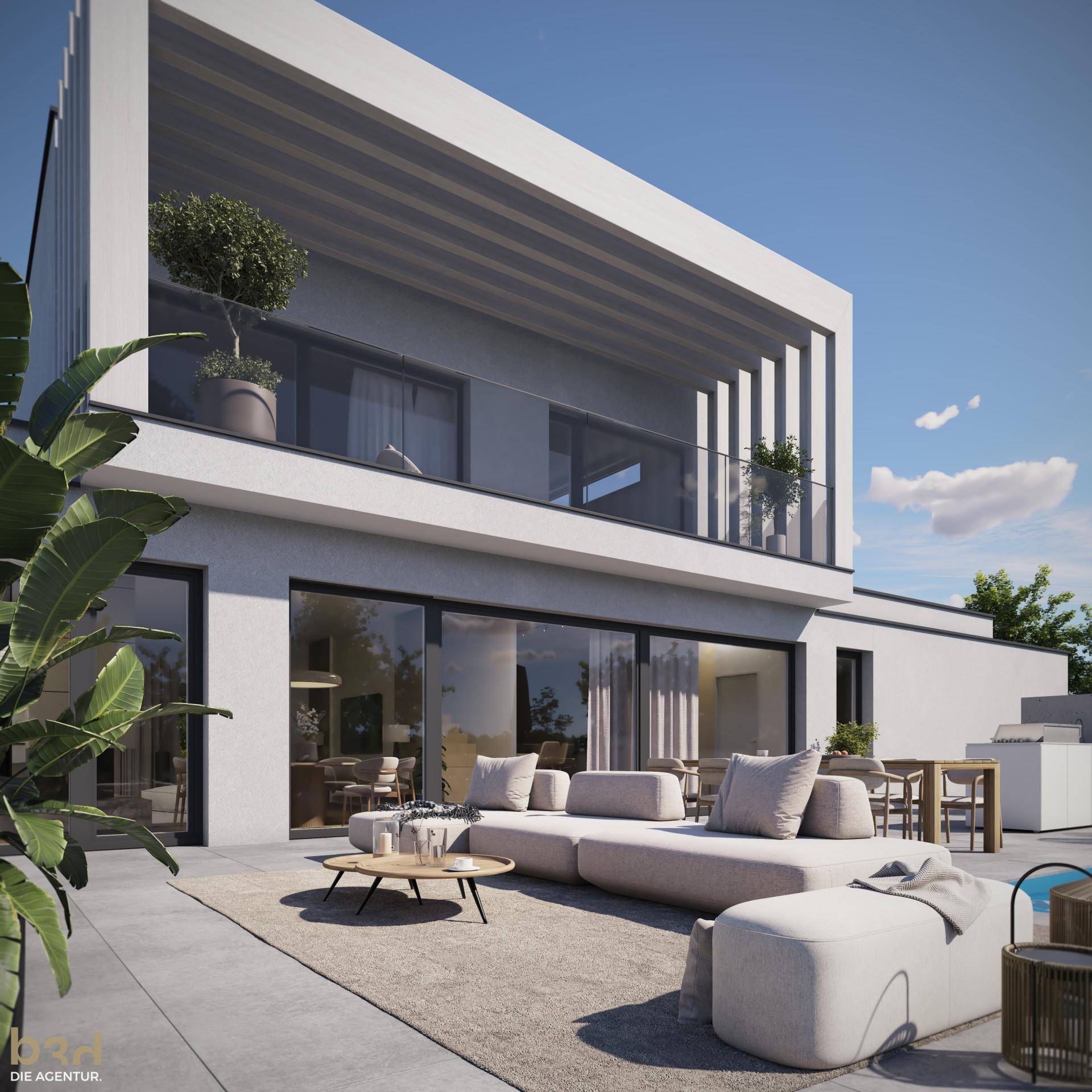 Großzügige Terrasse mit modernen Lounge-Möbeln und Zugang zu einem Balkon im Obergeschoss.