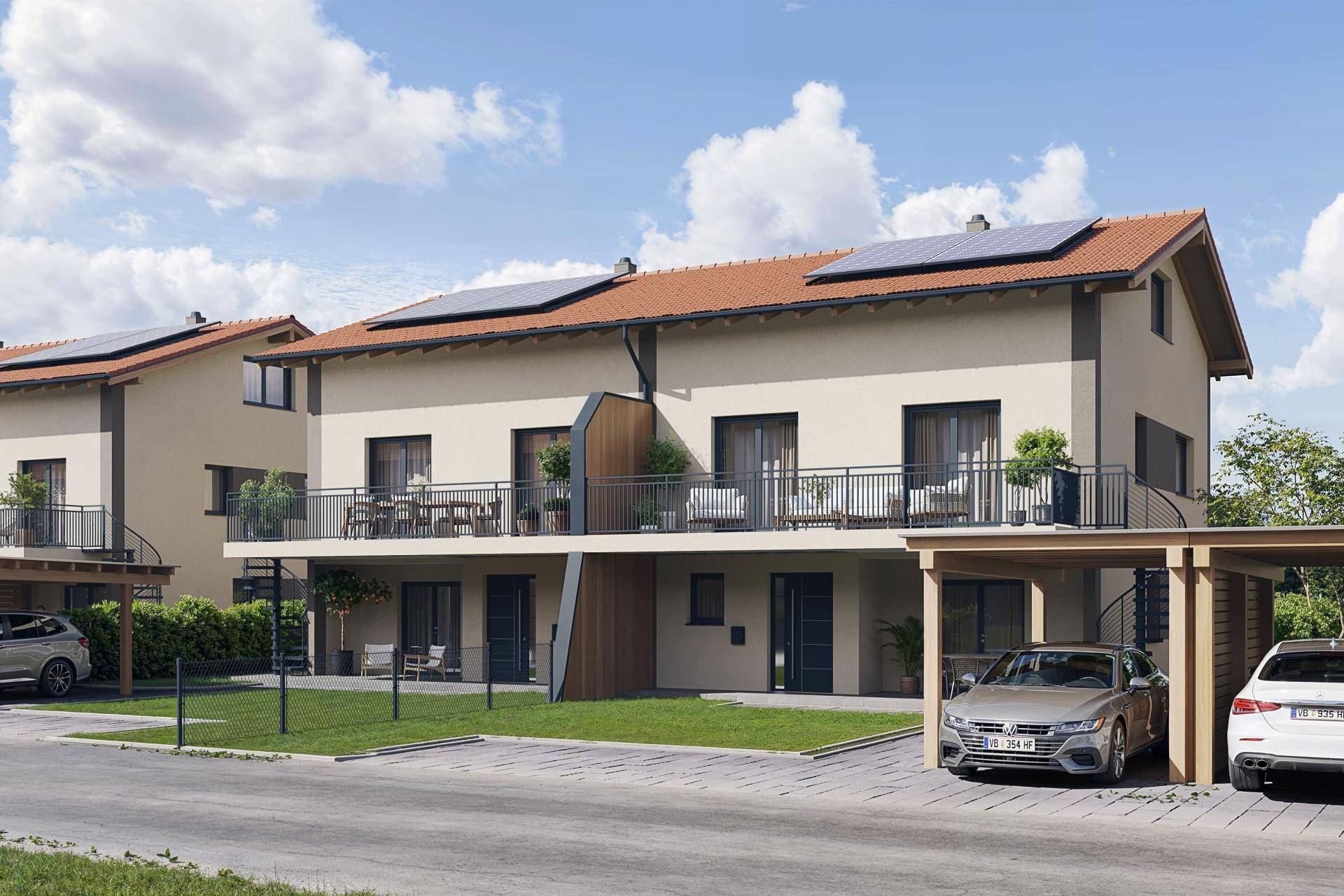 Moderne Reihenhäuser mit Balkonen, Carports und Photovoltaikanlagen unter blauem Himmel.