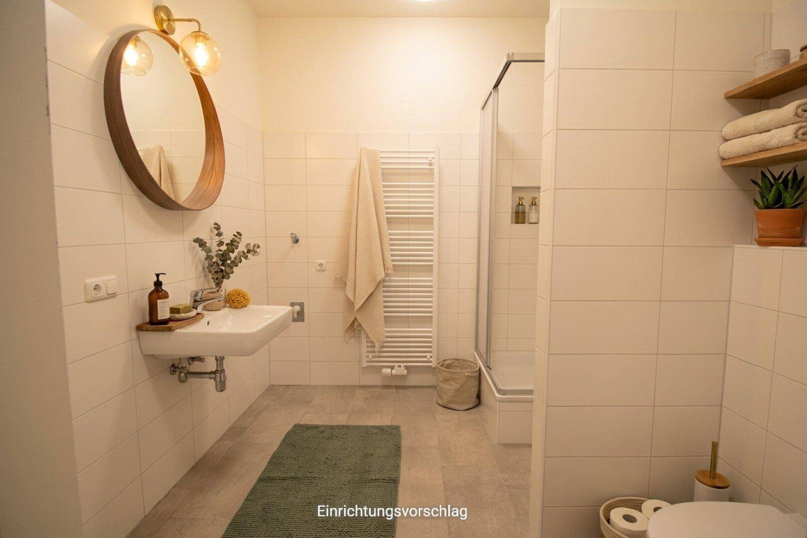 Modernes Badezimmer mit Dusche, Waschbecken, rundem Spiegel und beheiztem Handtuchhalter.