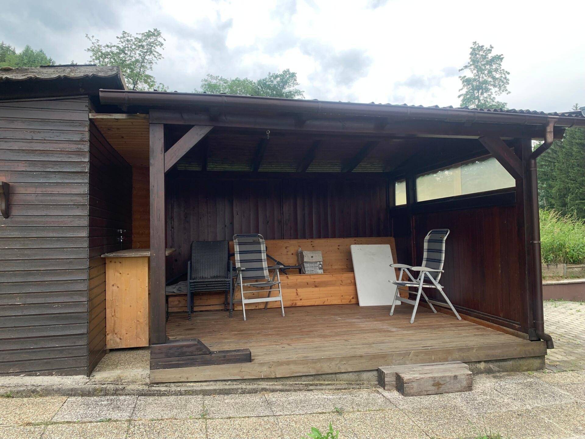 Gartenhütte mit überdachtem Sitzbereich