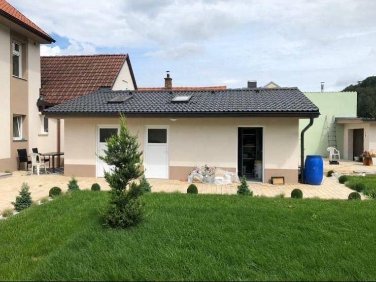 Rückansicht des Nebengebäudes mit Gartenbereich und Schuppen im Hintergrund.