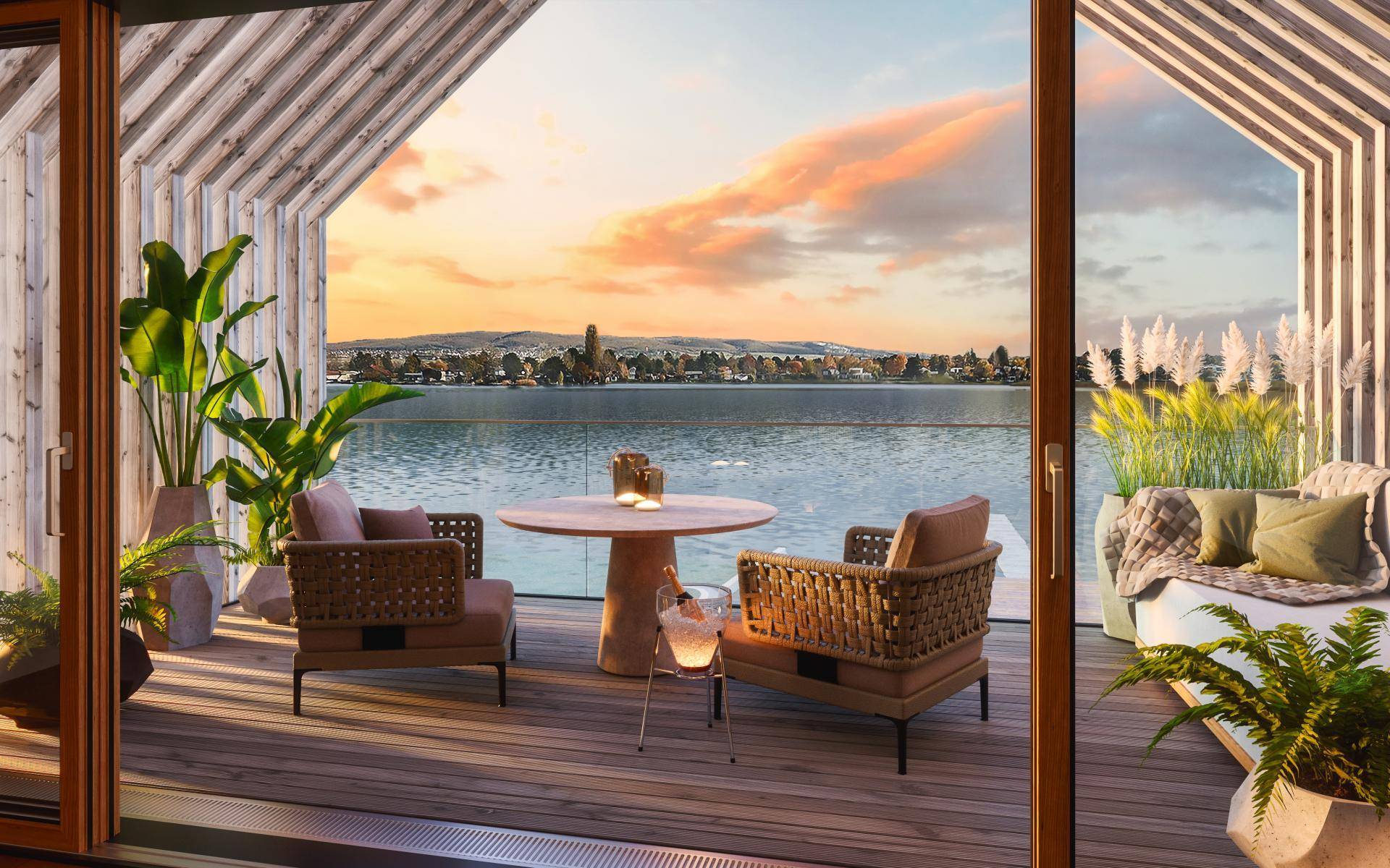 Moderne Terrasse mit Seeblick, bequemen Sitzgelegenheiten und stimmungsvoller Beleuchtung bei Sonnenuntergang.