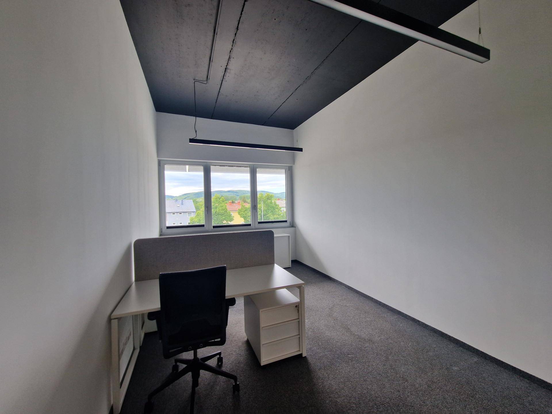 Modernes Einzelbüro mit Schreibtisch, Bürostuhl und weitem Blick aus dem Fenster.