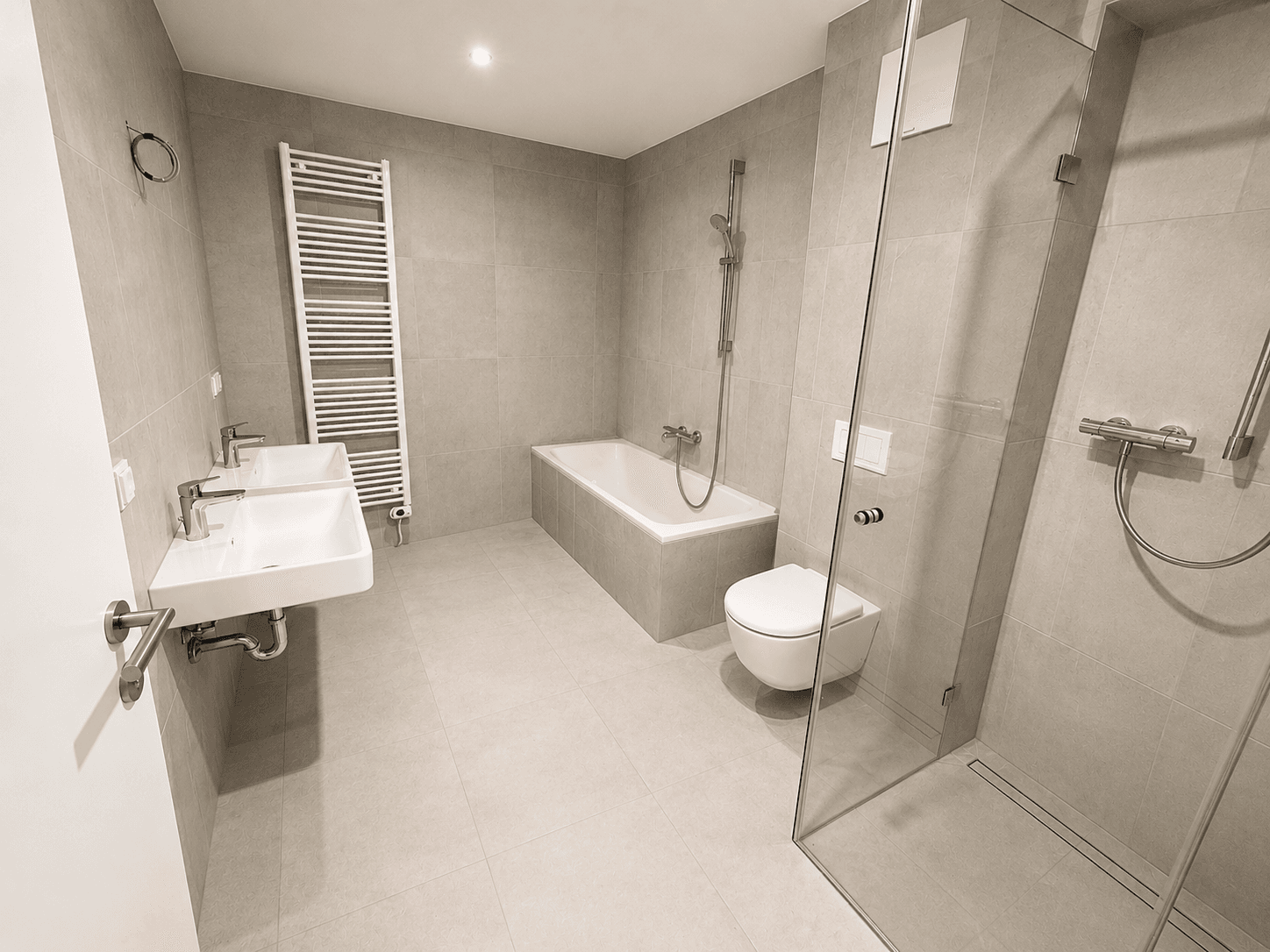 Modernes Badezimmer mit Doppelwaschbecken, Badewanne, ebenerdiger Dusche und Handtuchheizkörper.