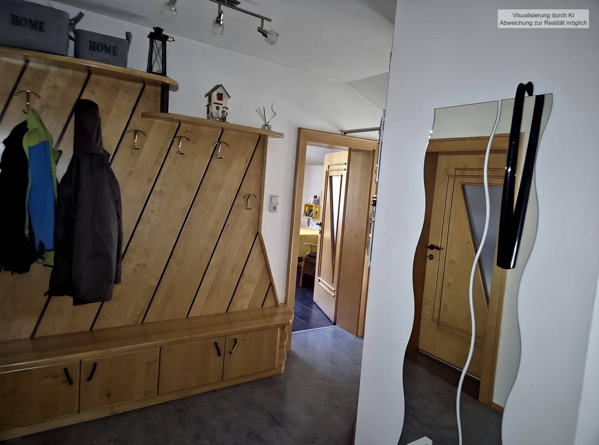 Heller Flur mit Holzgarderobe, Spiegel und Zugang zu weiteren Räumen.