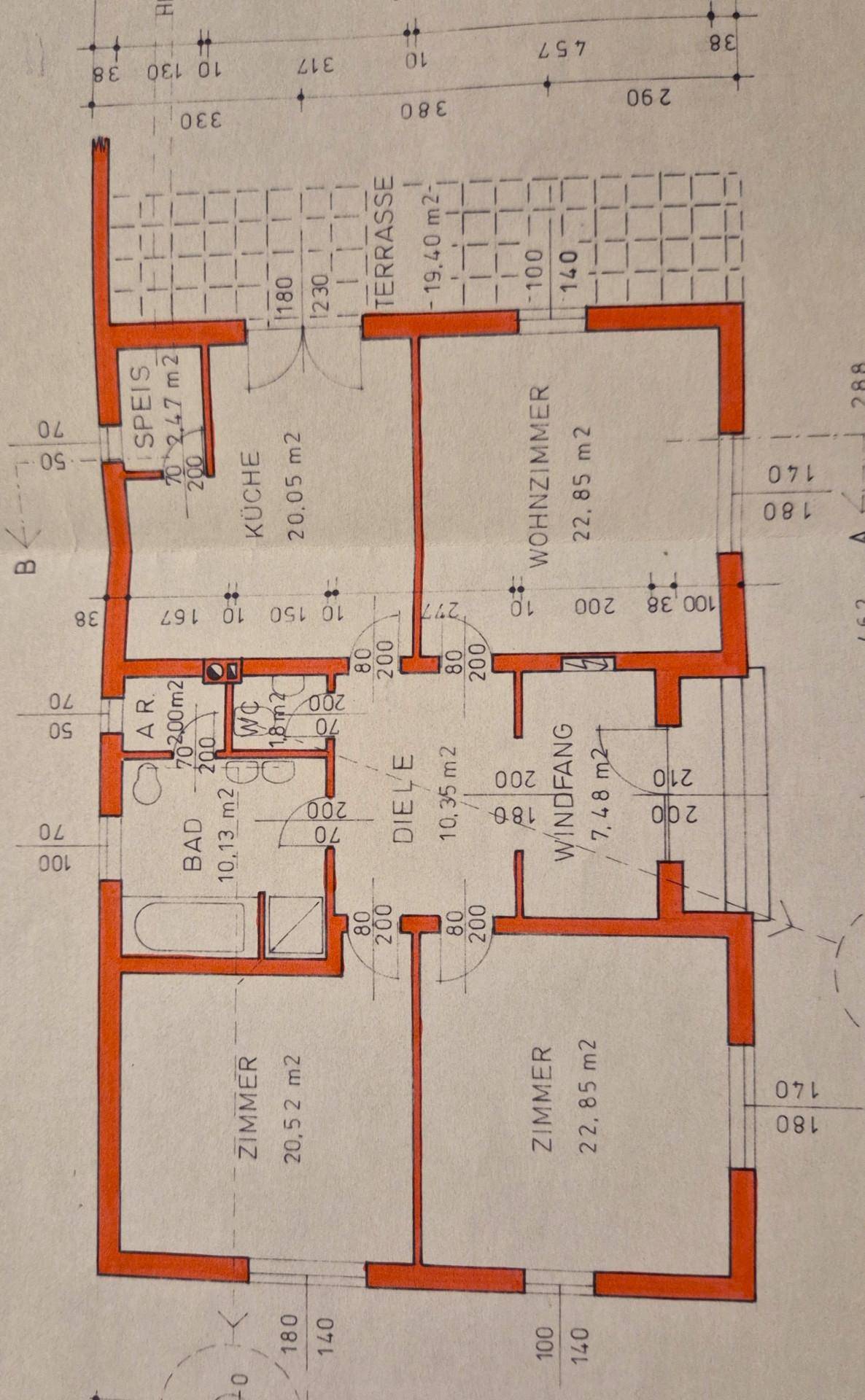 Grundriss des Erdgeschosses mit Wohnzimmer, Küche, Bad und Terrasse.