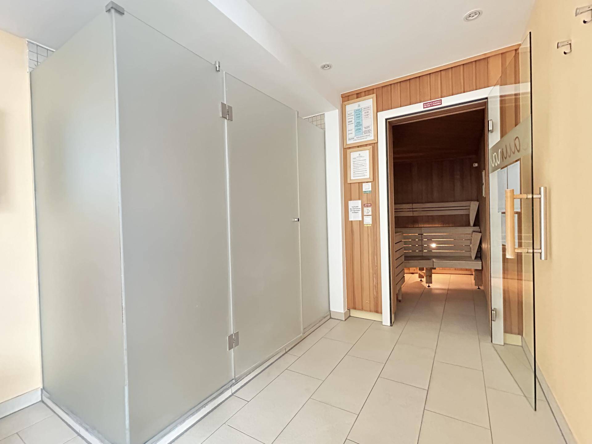 Entspannender Wellnessbereich mit einer holzvertäfelten Sauna und Umkleidekabinen.