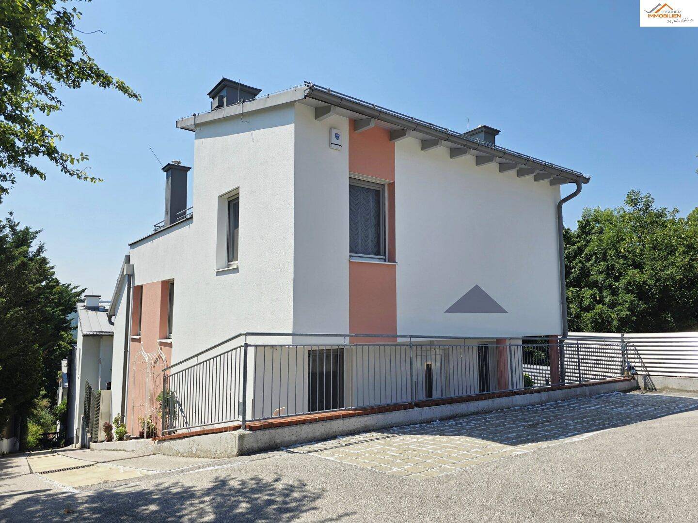 Seitenansicht des Hauses mit barrierefreier Rampe und moderner Fassadengestaltung.