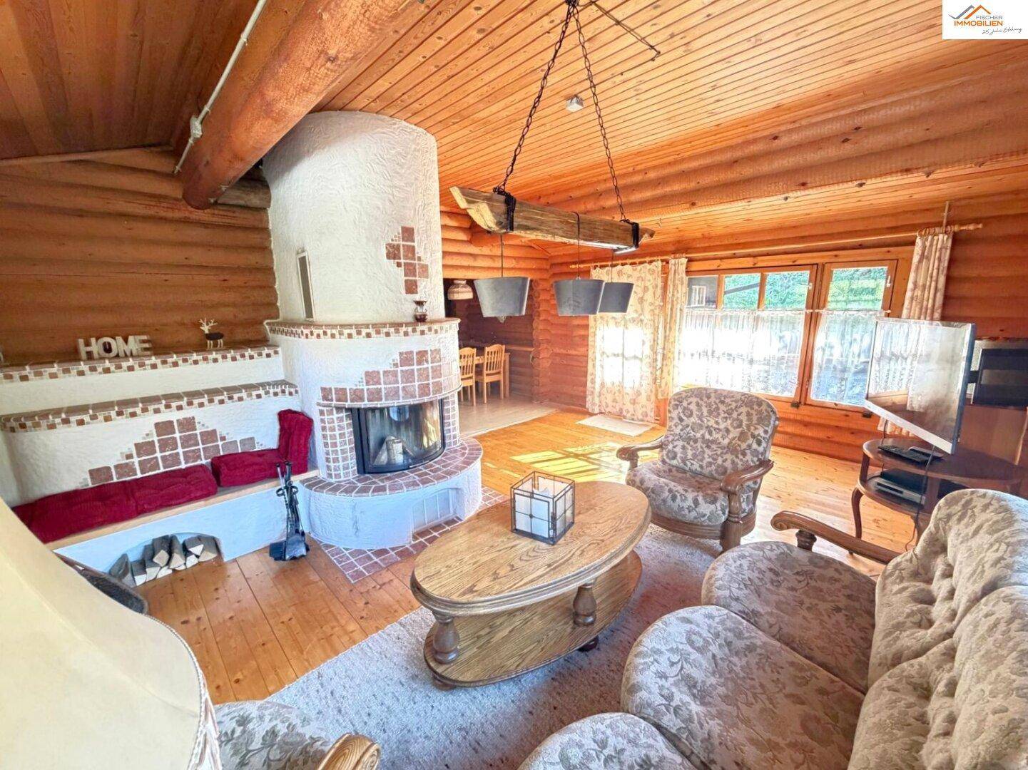 Rustikales Wohnzimmer mit Kamin, bequemen Sofas und Holzboden, ideal für entspannte Abende.