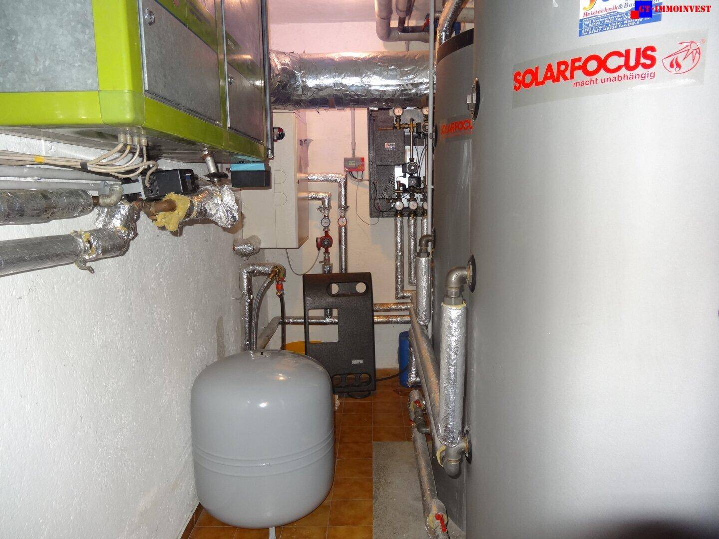 Heizungsraum mit großem Warmwasserspeicher der Marke Solarfocus und zahlreichen Rohrleitungen.