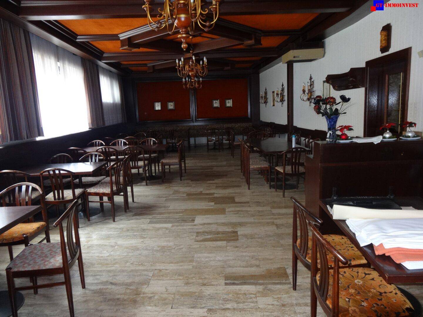 Weiterer Blick in den großen Speisesaal mit traditioneller Einrichtung, Holzbalkendecke und vielen Sitzgelegenheiten.