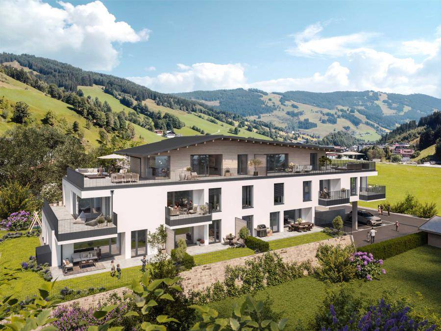Modernes Mehrfamilienhaus in alpiner Landschaft mit großzügigen Balkonen und Terrassen.