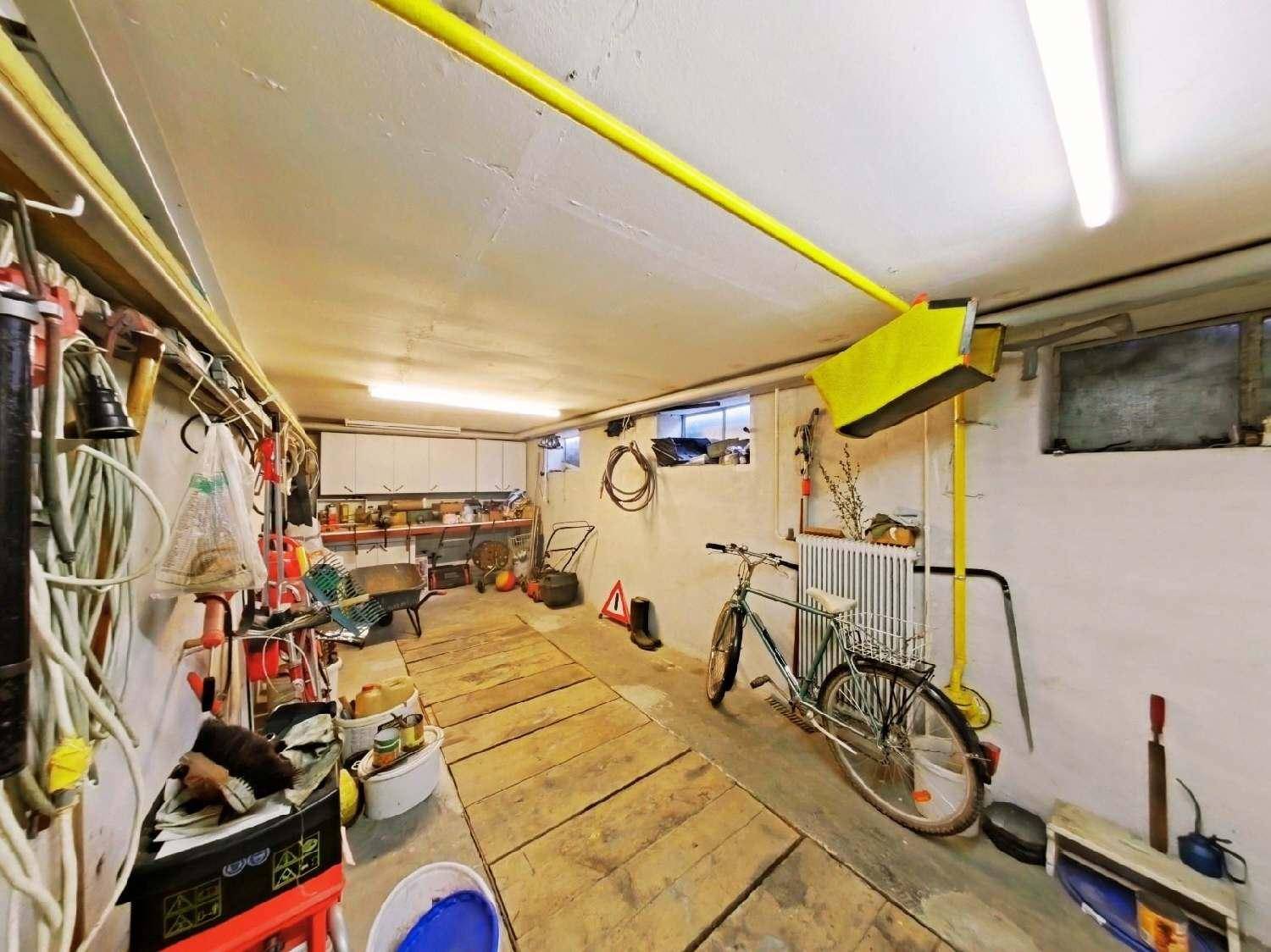 Geräumiger Kellerraum, genutzt als Werkstatt und Abstellfläche für Fahrräder.